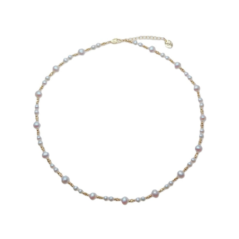 Freshwater Pearl Necklace with roundish potato-shaped white pearls and gold-plated beads on a delicate wire choker.