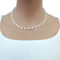Freshwater Pearl Necklace with 4 and 6mm roundish potato-shaped white pearls alternating with small gold-plated beads on a delicate wire choker.