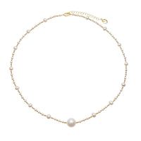 Freshwater Pearl Necklace featuring a large 11mm white pearl centerpiece with smaller roundish pearls and gold-plated beads on delicate wire.