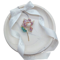 Flower Freshwater Pearl Brooch with purple enamel petals, pearl cluster, green leaf and slender gold-tone stalk.