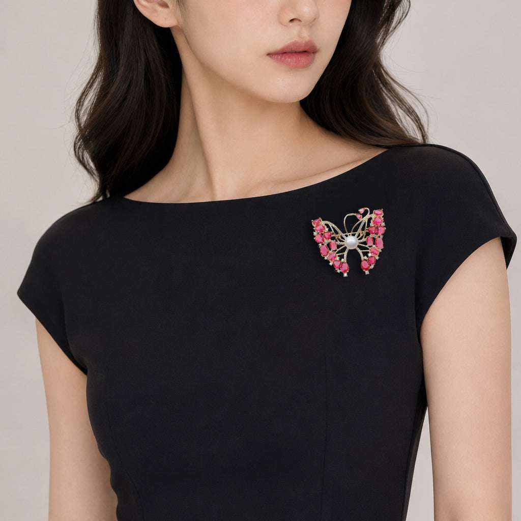 gold plated butterfly brooch with cubic zirconia red stones and freshwater pearl