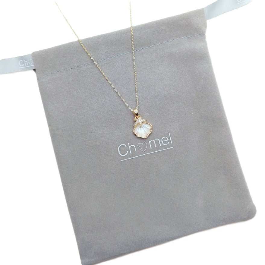 Shell pendant necklace with a gold-tone chain and white mother-of-pearl shell charm; Butterfly Cubic Zirconia accent