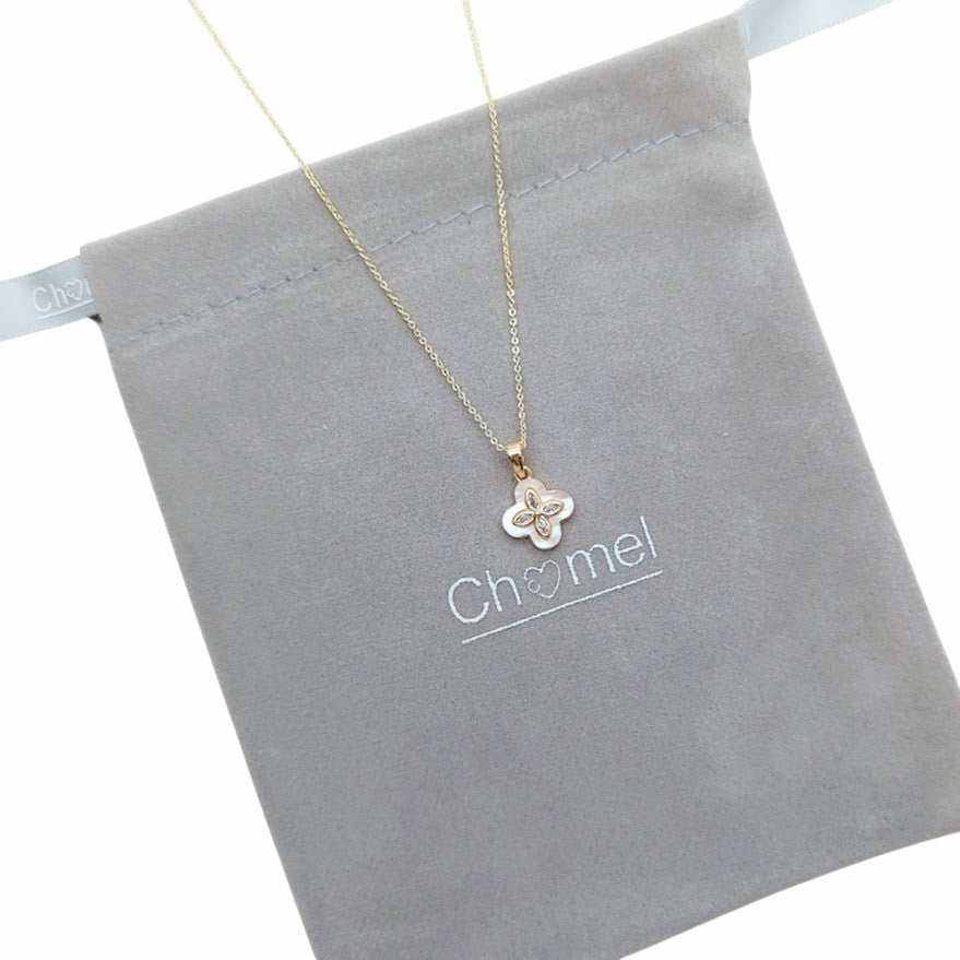 clover necklace with a petite four-leaf mother-of-pearl pendant edged in gold-tone cubic zirconia