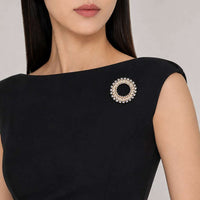 Gold plated round cubic zirconia brooch with baguette cuts
