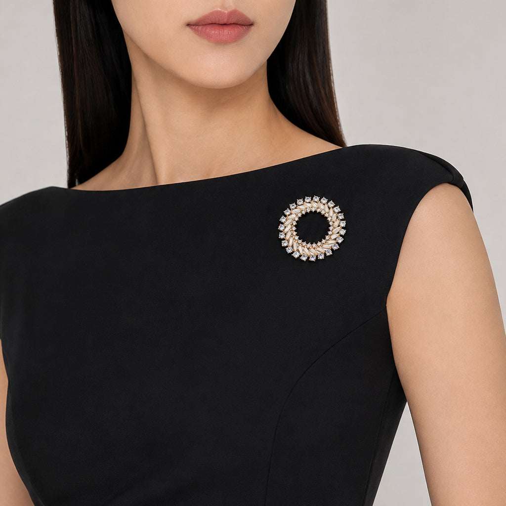 Gold plated round cubic zirconia brooch with baguette cuts