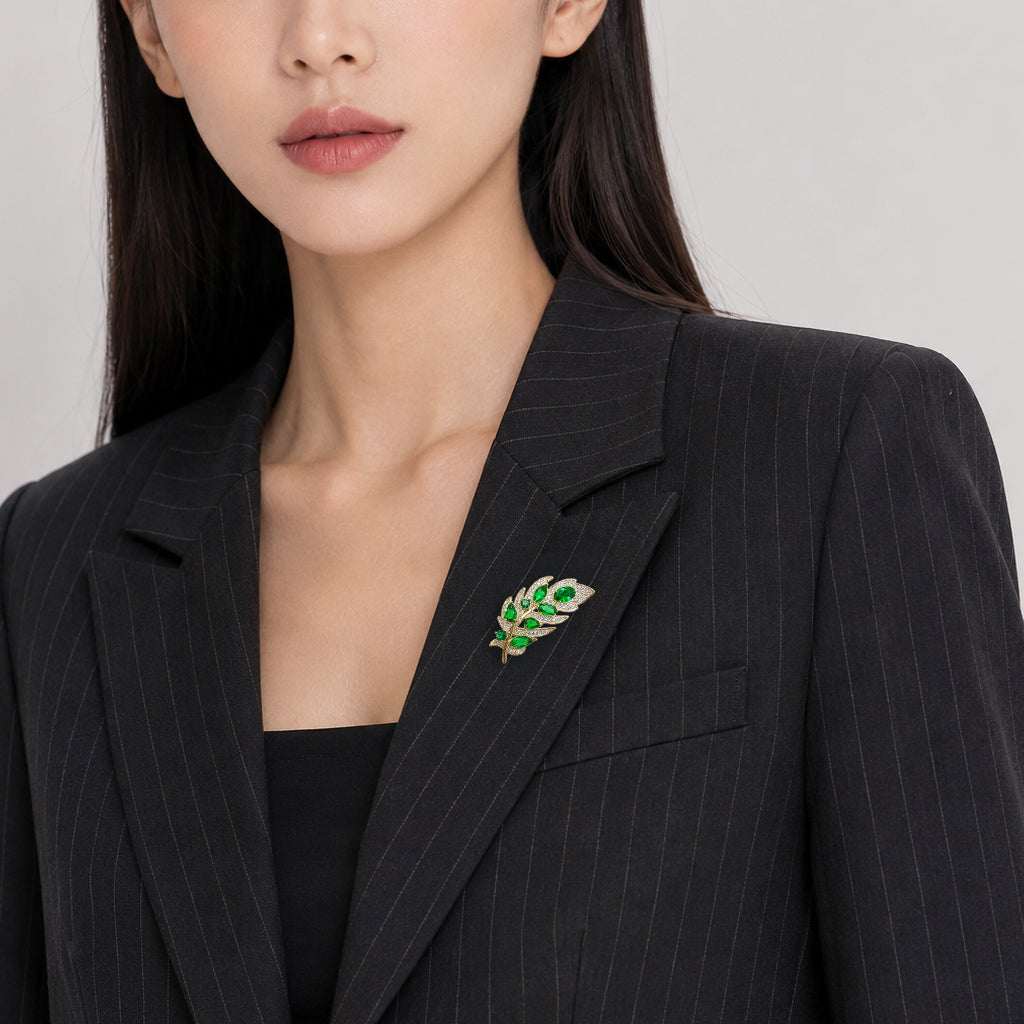 Gold plated leaf cubic zirconia brooch with green stones