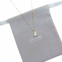 Dream Catcher Cubic Zirconia Necklace with a gold-tone fine chain and small pale blue, white, and gold pendant.