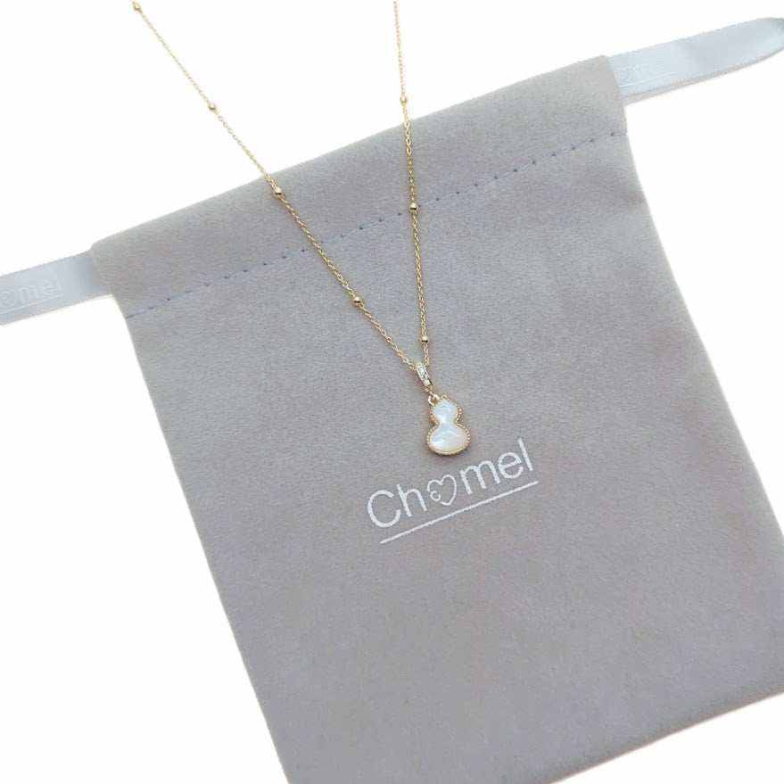 Dream Catcher Cubic Zirconia Necklace with a gold-tone fine chain and small pale blue, white, and gold pendant.