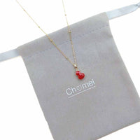 Dream Catcher Cubic Zirconia Necklace with a fine gold-tone chain and small red enamel pendant with gold trim.
