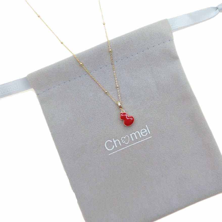Dream Catcher Cubic Zirconia Necklace with a fine gold-tone chain and small red enamel pendant with gold trim.