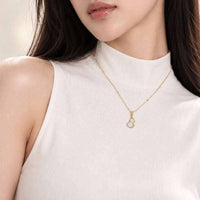 Dream Catcher Cubic Zirconia Necklace with a delicate gold-tone chain and small pale blue pendant edged in sparkling stones.