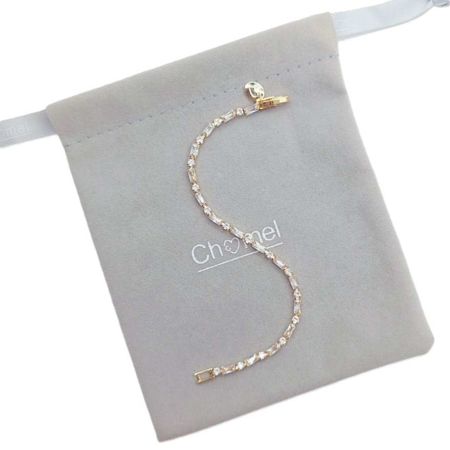 Cubic Zirconia Tennis Bracelet with a single row of clear stones and gold-tone settings, finished with a small clasp