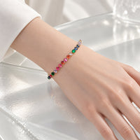 Cubic Zirconia Tennis Bracelet with colourful 4mm stones set in a gold-plated finish, worn on a wrist.