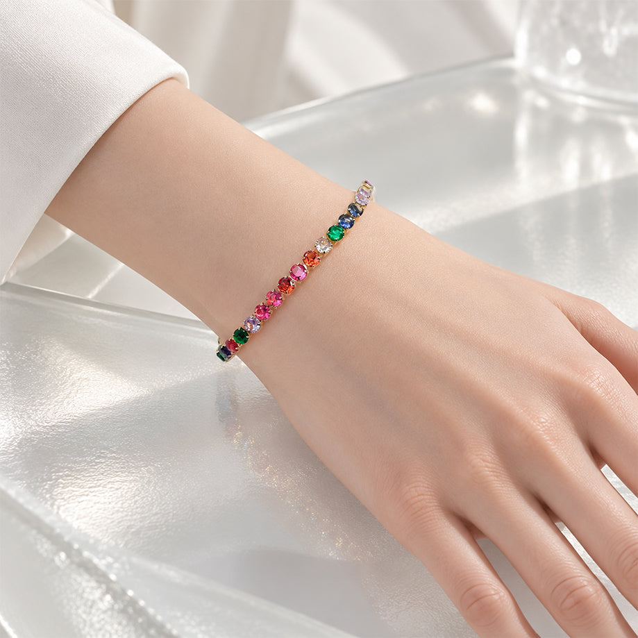 Cubic Zirconia Tennis Bracelet with colourful 4mm stones set in a gold-plated finish, worn on a wrist.