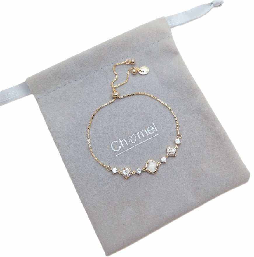 Cubic Zirconia Tennis Bracelet in gold-tone chain with clear and white stones, including a square centerpiece and adjustable slider.