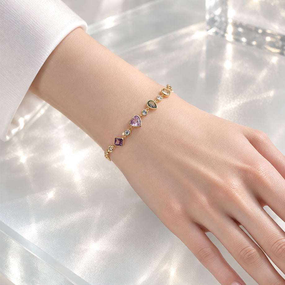 Gold-tone cz bracelet with colourful heart, teardrop, oval and square stones, small clear accents and an adjustable slider clasp.