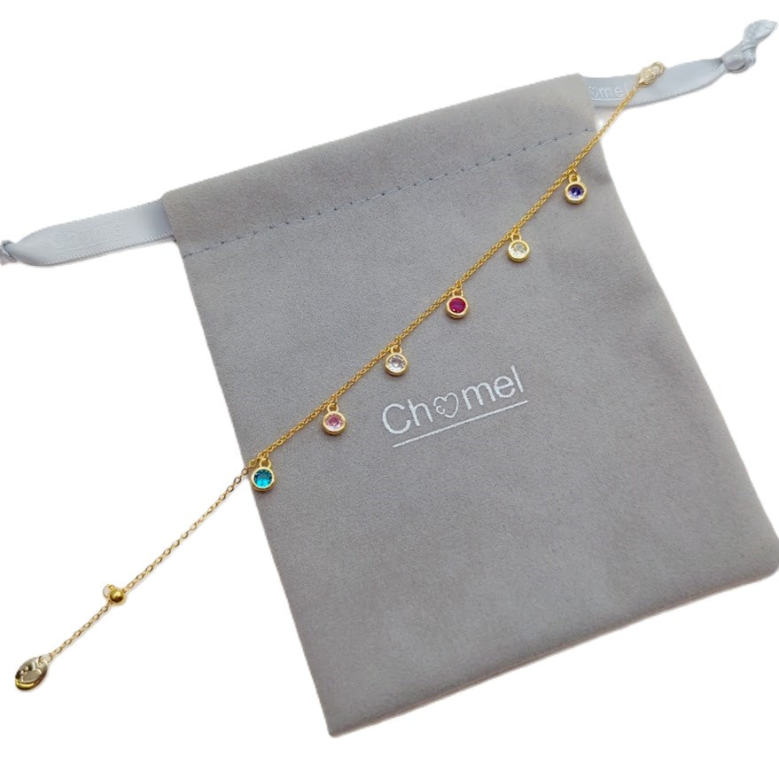 Cubic zirconia tennis bracelet with colorful round stones and gold-plated rims on adjustable chain