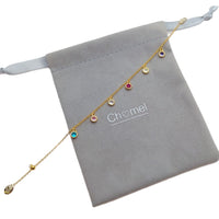 Cubic zirconia tennis bracelet with colorful round stones and gold-plated rims on adjustable chain
