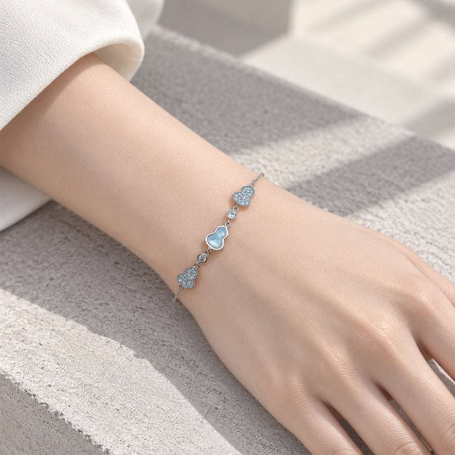 cz bracelet with a delicate silver-tone chain, featuring sparkling blue heart-shaped stones and small crystal accents