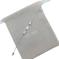 Silver-tone cz bracelet with a delicate chain, sparkling cubic zirconia beads and a white mother-of-pearl gourd charm.