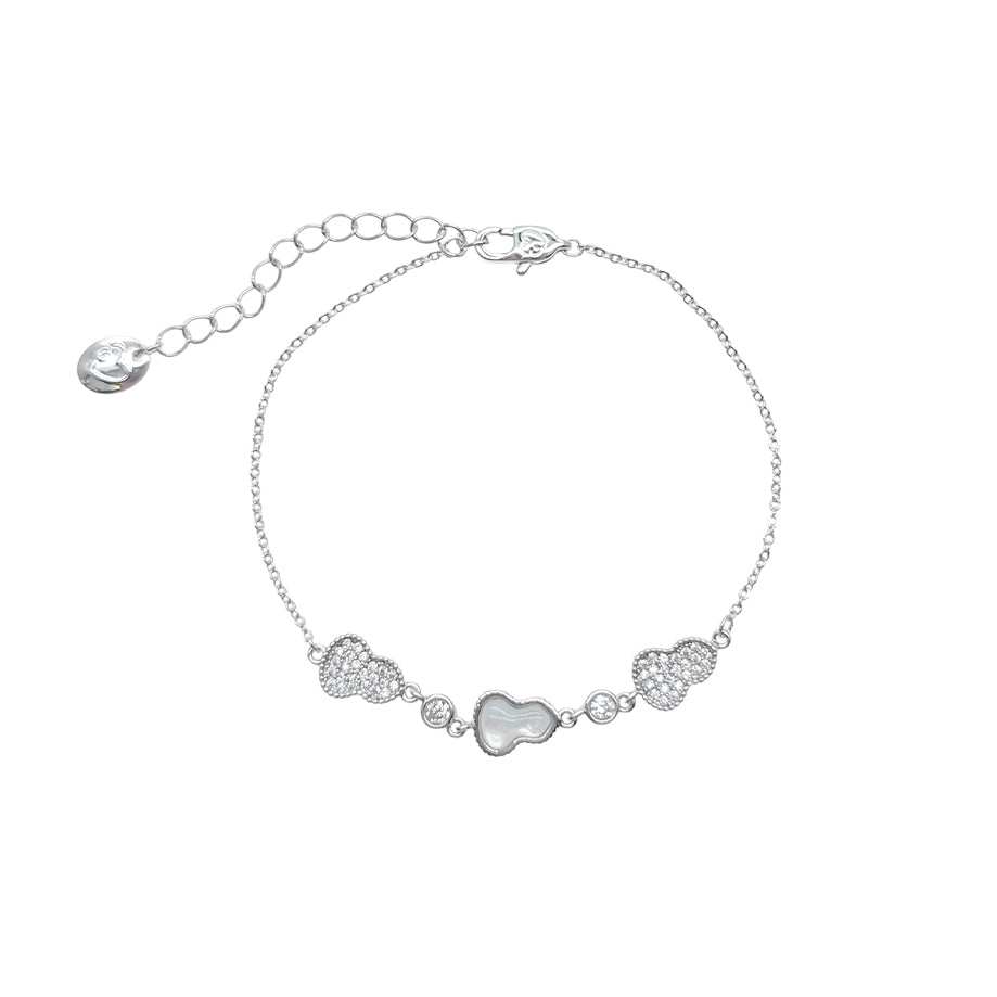 Silver-toned cz bracelet with a fine chain, a mother-of-pearl gourd charm, and sparkling cubic zirconia accents.