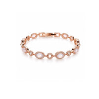Rose gold-toned cz bracelet with oval milky moonstone-like cabochons, framed by rows of sparkling clear stones.