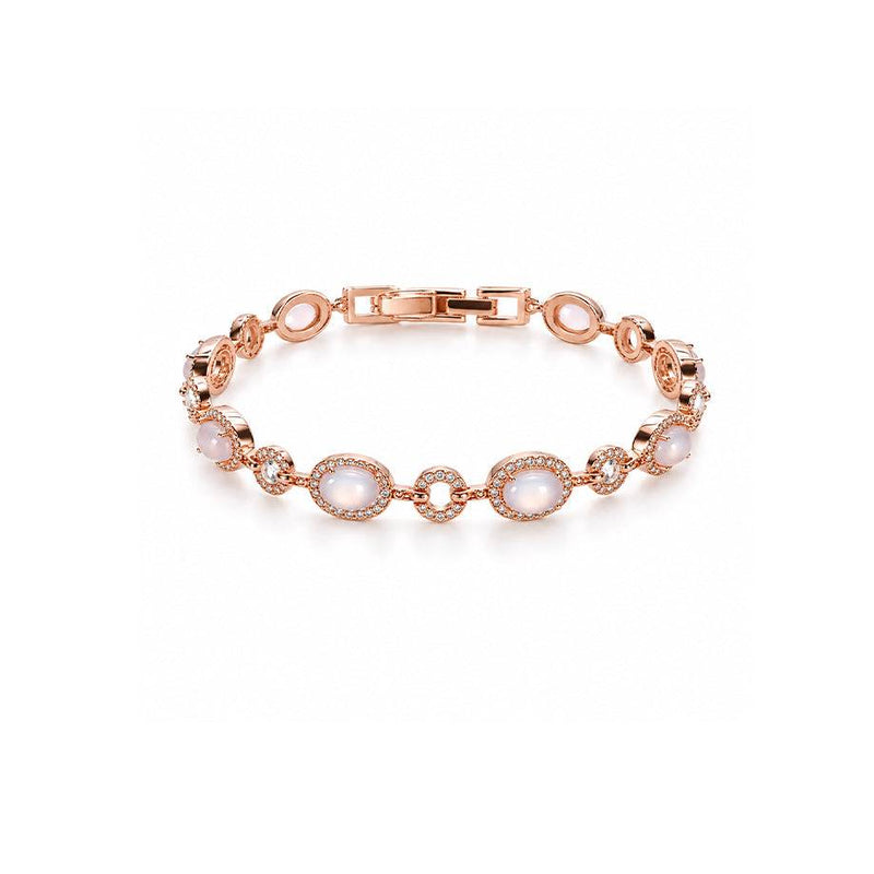 Rose gold-toned cz bracelet with oval milky moonstone-like cabochons, framed by rows of sparkling clear stones.