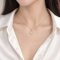Gold-tone CZ Necklace with a fine chain and small floral pendant featuring clear sparkling stones and a central detail.