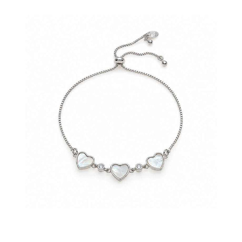 Dainty bracelet in silver-tone metal with three white mother-of-pearl heart charms and small sparkling stones