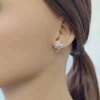Cubic zirconia flower bouquet clip-on earrings with ribbon detailing and rhodium-plated finish