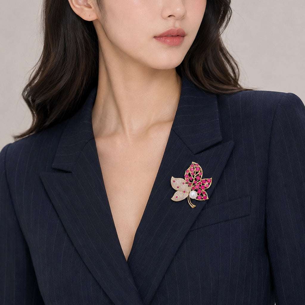 Gold plated maple leaf brooch with freshwater pearl and red stones