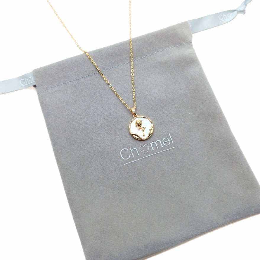 Flower Pendant Necklace with a gold-tone chain and round ivory pendant featuring a delicate gold flower motif