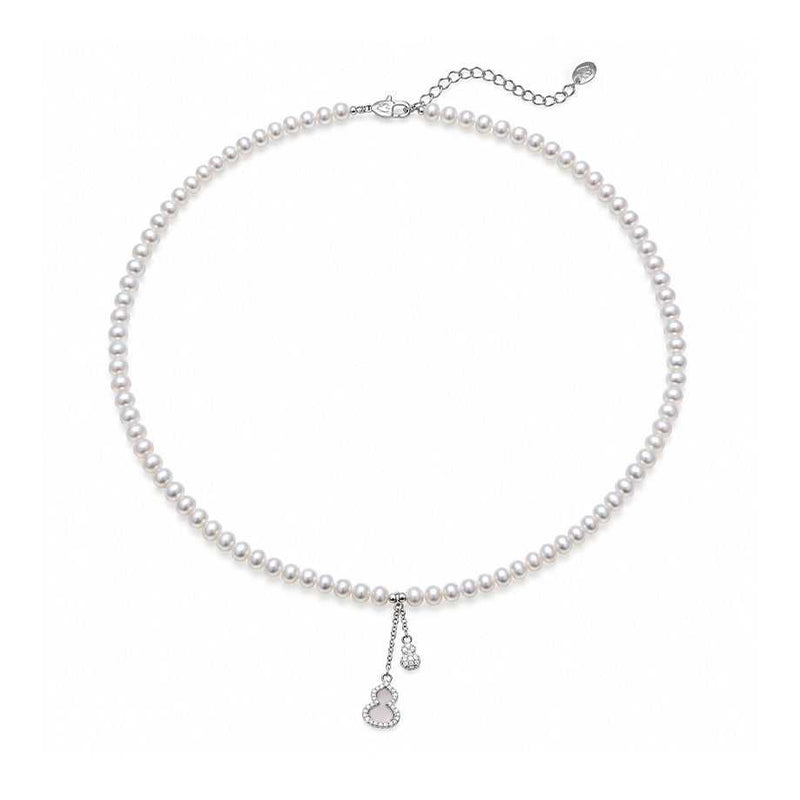 Freshwater Pearl necklace with small lustrous white pearls, silver-tone clasp and two delicate dangling charms.