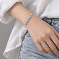 Freshwater Pearl Bracelet with a delicate row of round, lustrous pale pearls on a fine silver-tone chain with clasp.
