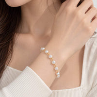 Freshwater Pearl Bracelet with lustrous white round pearls and small gold-tone spacer beads on a delicate strand