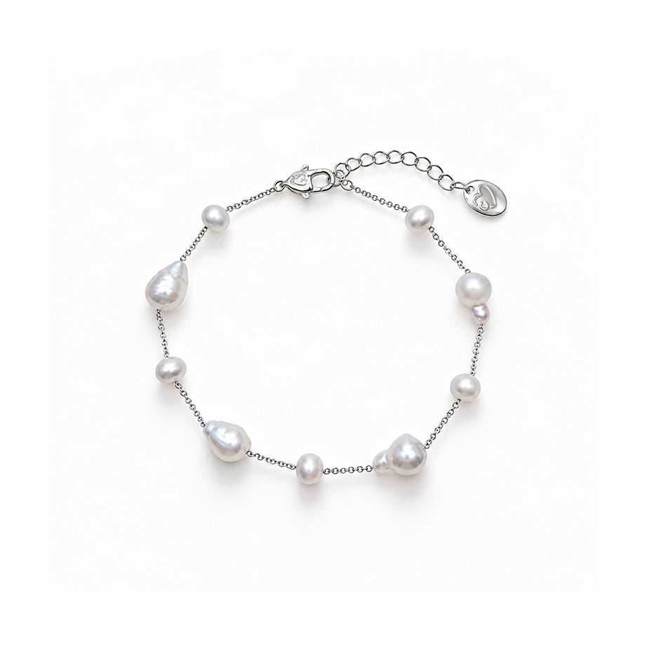 Freshwater Pearl Bracelet with lustrous white round and baroque pearls spaced along a delicate silver-tone chain with an adjustable clasp.