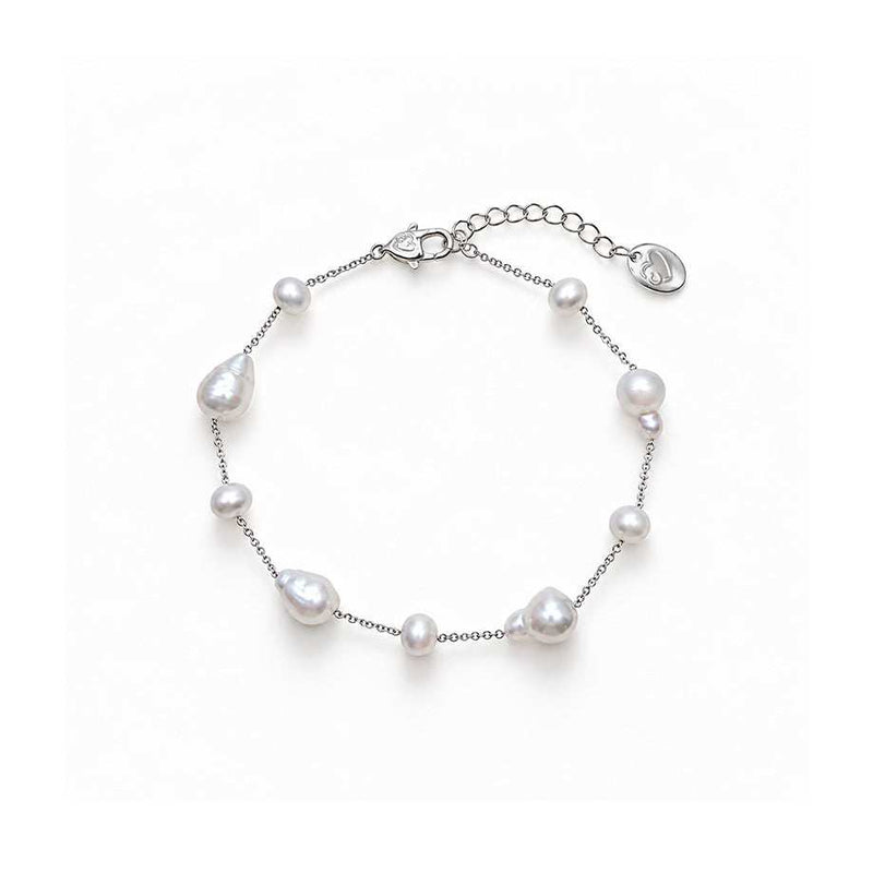 Freshwater Pearl Bracelet with lustrous white round and baroque pearls spaced along a delicate silver-tone chain with an adjustable clasp.