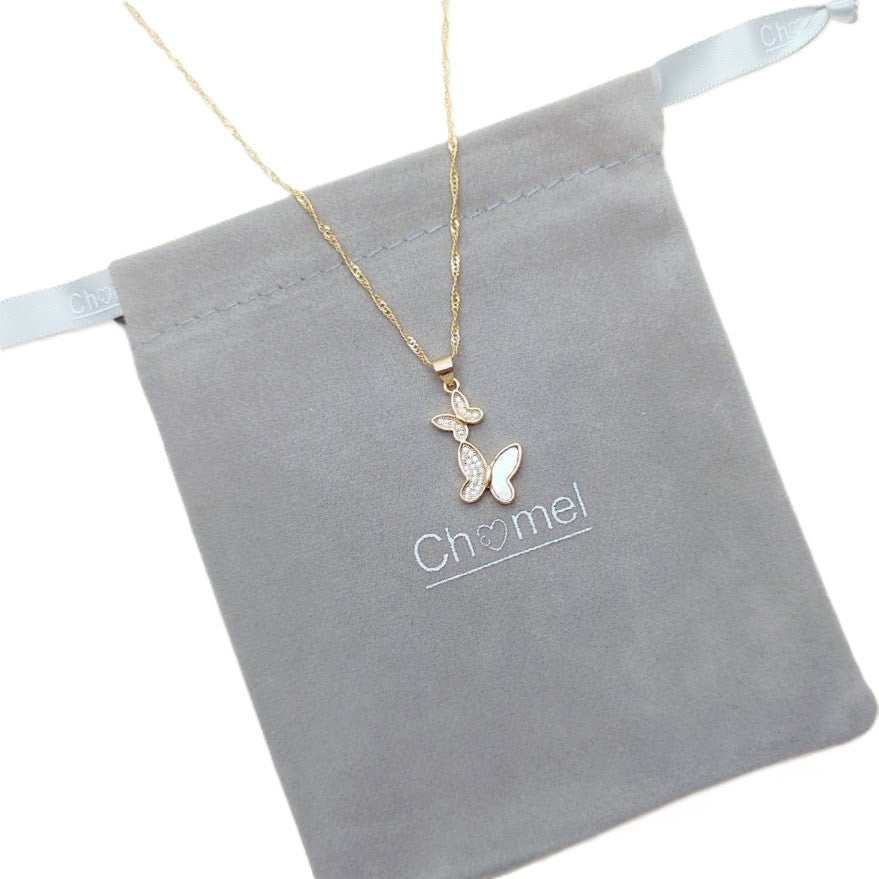 Gold butterfly necklace with a fine chain and two delicate butterfly pendants, one with shimmering pale inlays