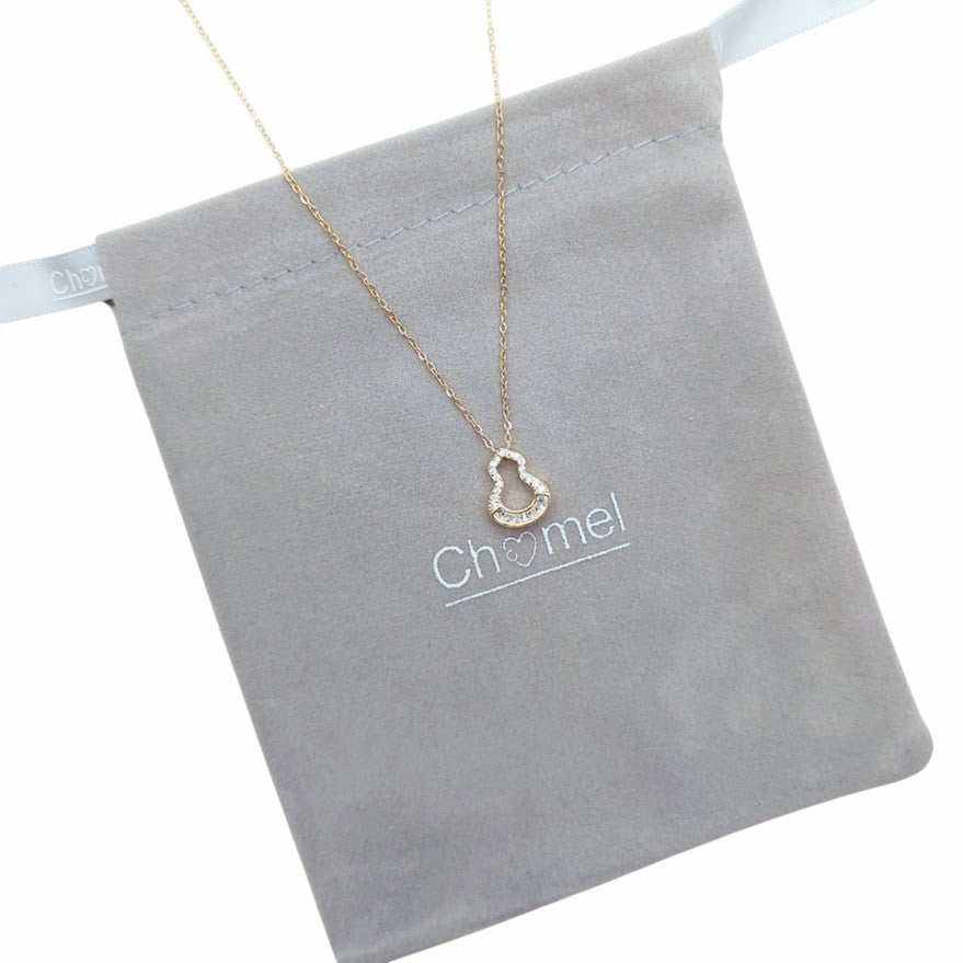 Gold pendant necklace with a fine gold-tone chain and small open heart-shaped pendant edged with clear stones