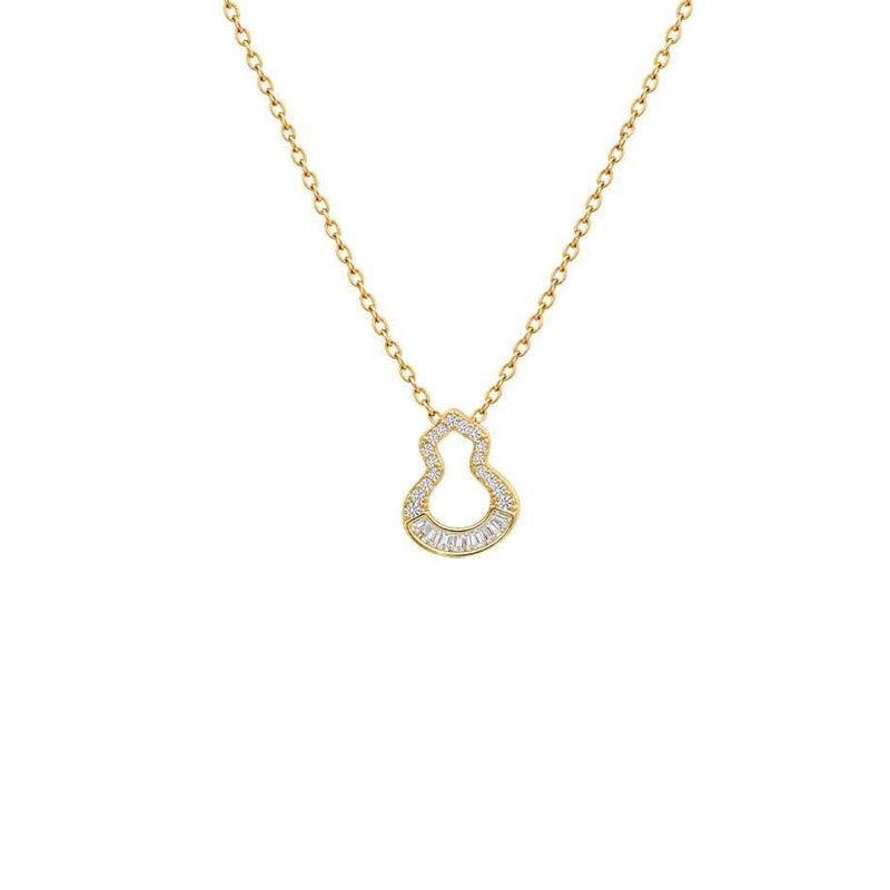 Gold pendant necklace with a delicate chain and open hulu-shaped pendant set with sparkling cubic zirconia