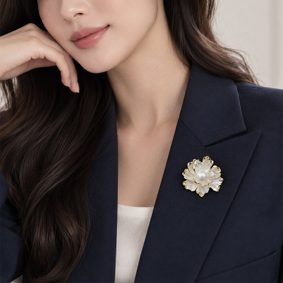 White enamel flower brooch with gold plated edges and a 14mm simulated pearl center