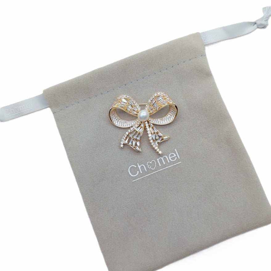 Gold plated ribbon brooch with 7mm freshwater pearl and cubic zirconia