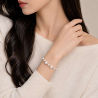 Simulated pearl bracelet with adjustable pull string and rhodium beads