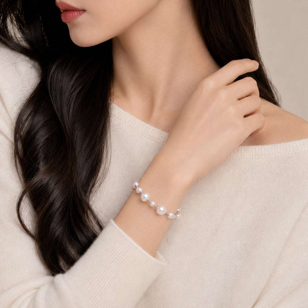 Simulated pearl bracelet with adjustable pull string and rhodium beads