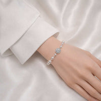 Simulated pearl bracelet with cubic zirconia and adjustable pull string