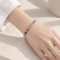 Colourful cubic zirconia slider bracelet in a silver-tone setting, with rectangular stones and an adjustable fit.