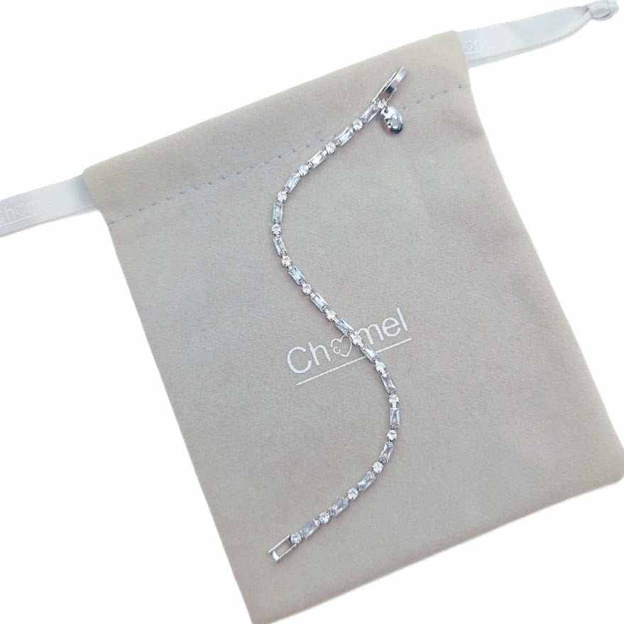 Tennis bracelet with a single row of clear baguette-cut stones in a slim silver-tone setting and clasp