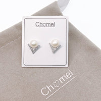 Freshwater pearl and cubic zirconia V-shaped silver stud earrings on display card with beige pouch background