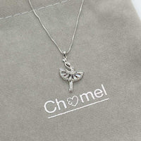 Ballerina cubic zirconia pendant necklace with rhodium plating and adjustable chain on gray background