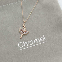 Ballerina cubic zirconia pendant necklace with rosegold plating on gray background